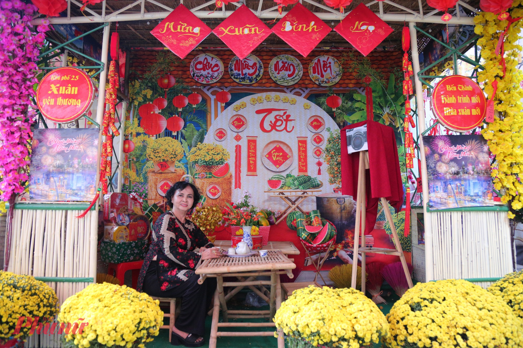 Các tiểu cảnh được dựng khéo léo bằng vật liệu mộc mạc như tre, nứa, mái lá, tái hiện hình ảnh gian nhà quê ngày Tết. Bên trong là bàn tre nhỏ với ấm trà, bánh mứt, dưa hấu, bánh chưng, bánh tét, những biểu tượng quen thuộc của Tết Việt. 