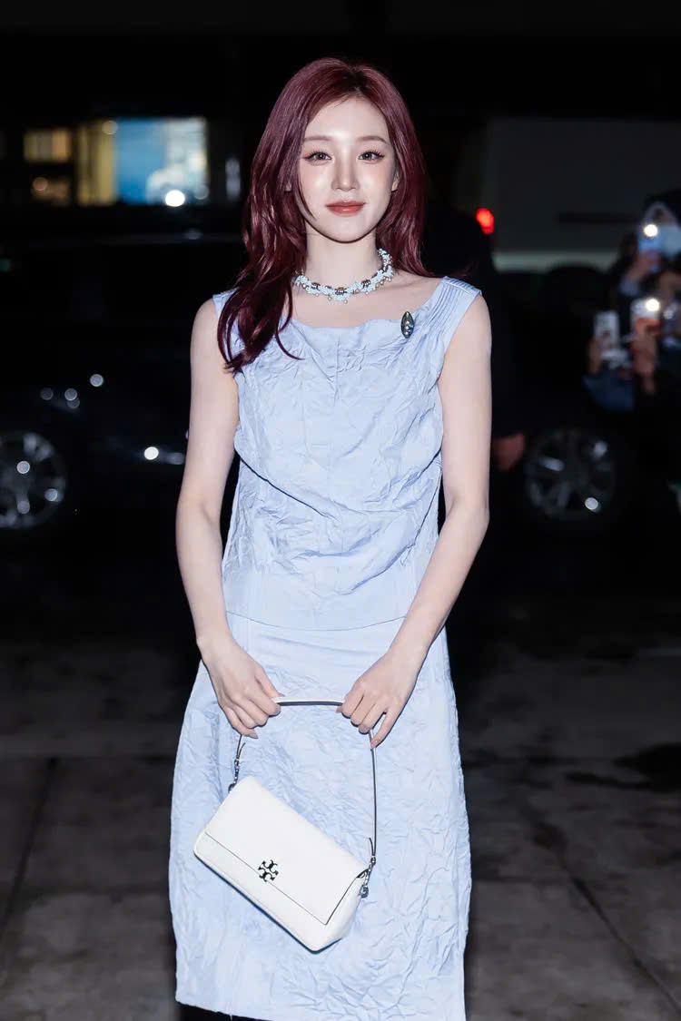 Yuqi (Tống Vũ Kỳ) gây ấn tượng với vẻ ngoài nữ tính, nhẹ nhàng trong bộ váy xanh pastel phom dáng tối giản. Chất liệu vải có độ nhăn tự nhiên tạo cảm giác mềm mại, kết hợp cùng túi xách trắng và trang sức tinh tế, mang đến hình ảnh thanh lịch, trẻ trung nhưng vẫn rất trang nhã, đúng tinh thần quiet luxury đang được ưa chuộng.