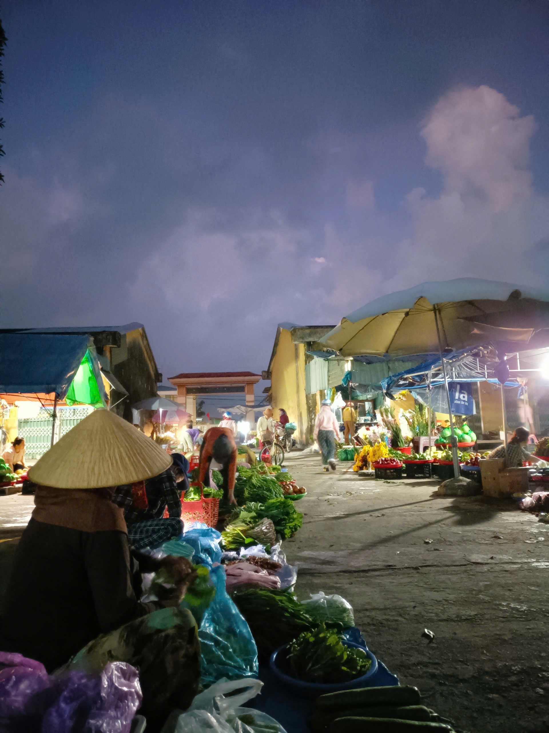 Chợ quê đầu năm Mới 5 giờ sáng, khi bầu trời vẫn còn nguyên gam xám xanh đặc trưng của những ngày đầu năm, mây còn lững lờ trôi và sương vẫn lảng bảng trên mái tôn, các sạp hàng đã bày ra tươm tất.