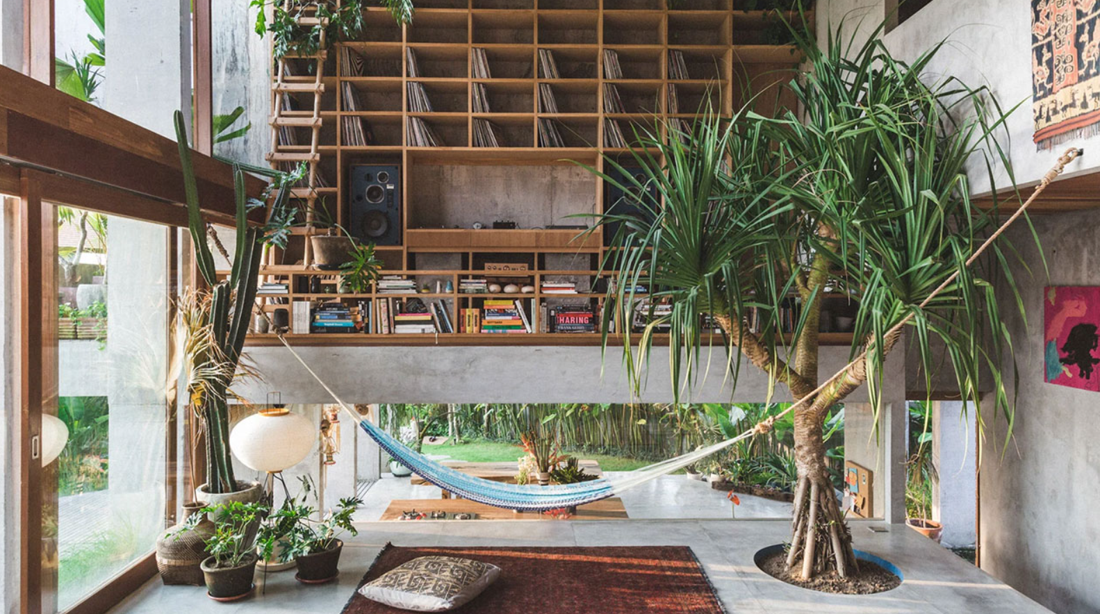 Tọa lạc tại Bali ngay giữa những cánh đồng lúa, Ngôi nhà Nhiệt đới theo phong cách Brutalist được thiết kế bởi Patisandhika Sidarta (hiện thuộc công ty kiến ​​trúc Sidarta and Sandjaja ) và nhà thiết kế Daniel Mitchell. Ngôi nhà này gây ấn tượng với không gian mở rộng lớn và có bố cục nhiều tầng. Trong phòng khách, có một chiếc võng để thư giãn bên cạnh một cây được trồng ngay trên khoảng lõm sàn bê tông. Ảnh: @Tommaso Riva.