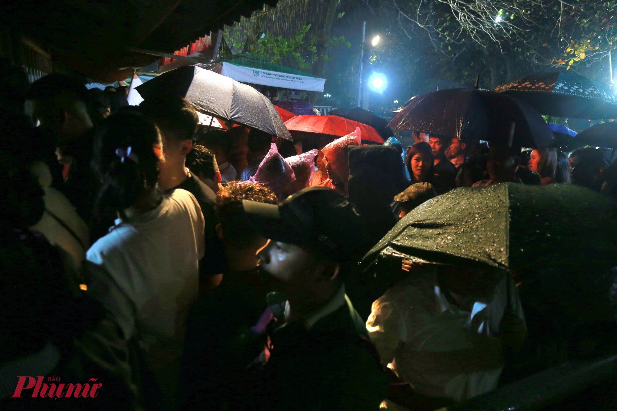 Cơn mưa mỗi lúc một nặng hạt, hàng trăm người che ô, mặc áo mưa đứng san sát nhau trước khu vực “Nơi phát ấn lộc”. Không khí vừa trang nghiêm, vừa khẩn trương khi thời điểm phát ấn đang đến gần.