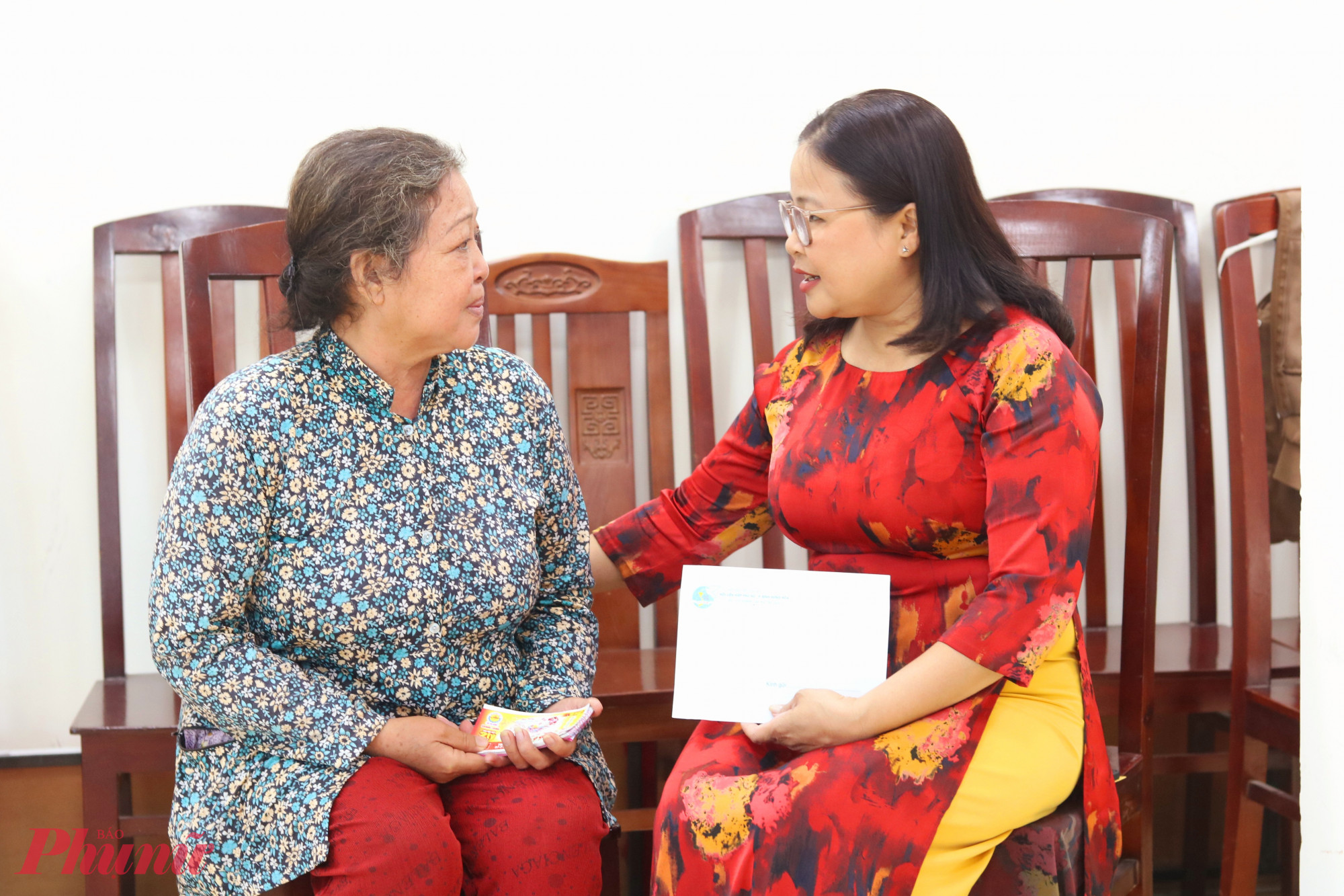 Bà Nguyễn Thị Minh Hậu – Phó chủ tịch Ủy ban MTTQ Việt Nam phường Bình Hưng Hòa, Chủ tịch Hội LHPN phường (bìa phải) – trao vốn và động viên bà Tống Bích Vân cố gắng điều trị bệnh - Ảnh: Mẫn Nhi