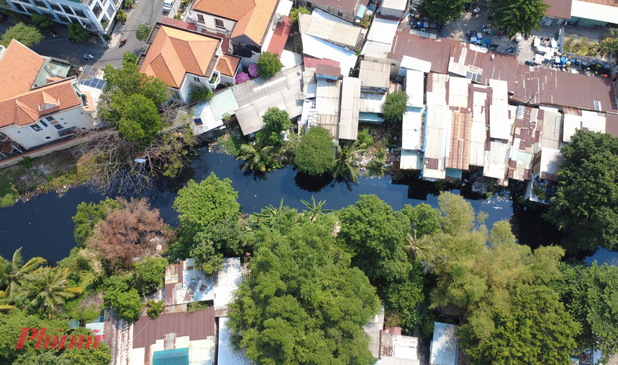 Dọc tuyến rạch, cây cối mọc dày, nhiều căn nhà tạm bợ vẫn tồn tại sát mép nước. 