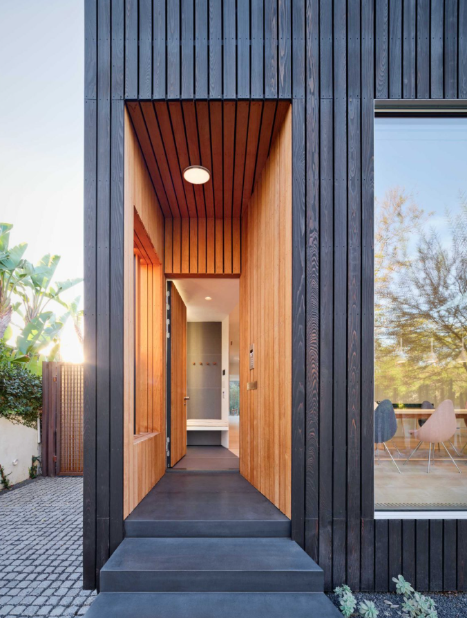 Lối vào ốp gỗ có những đường nét hài hòa cùng lớp ván gỗ cháy xém bên ngoài. Ảnh: @Aalso Architects, HYCArch.