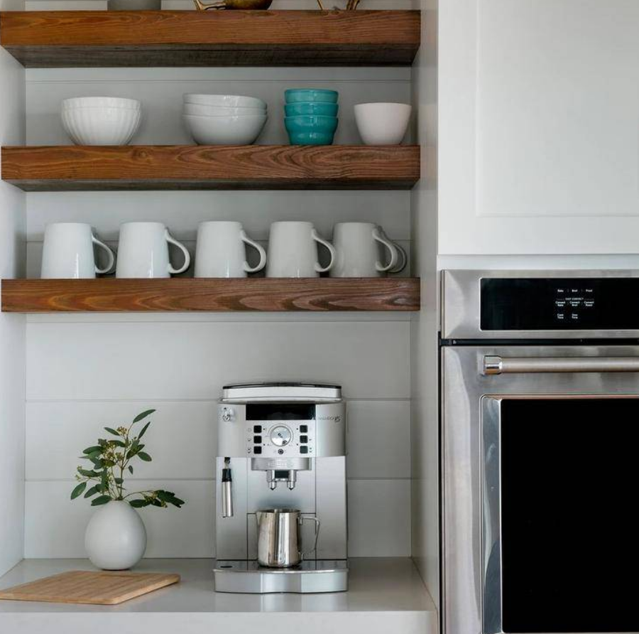 Nhà bếp có khu pha cà phê với kệ gỗ mộc mạc đặt trên nền ốp gỗ trắng. Ảnh: @Kitchen Studio of Glen Ellyn. 