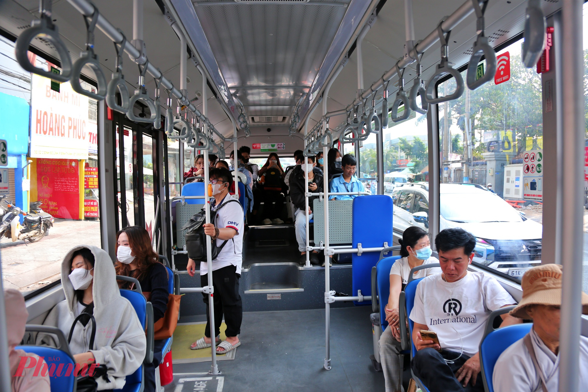 Hành khách đi xe buýt điện ở TPHCM - Ảnh: Nguyễn Văn