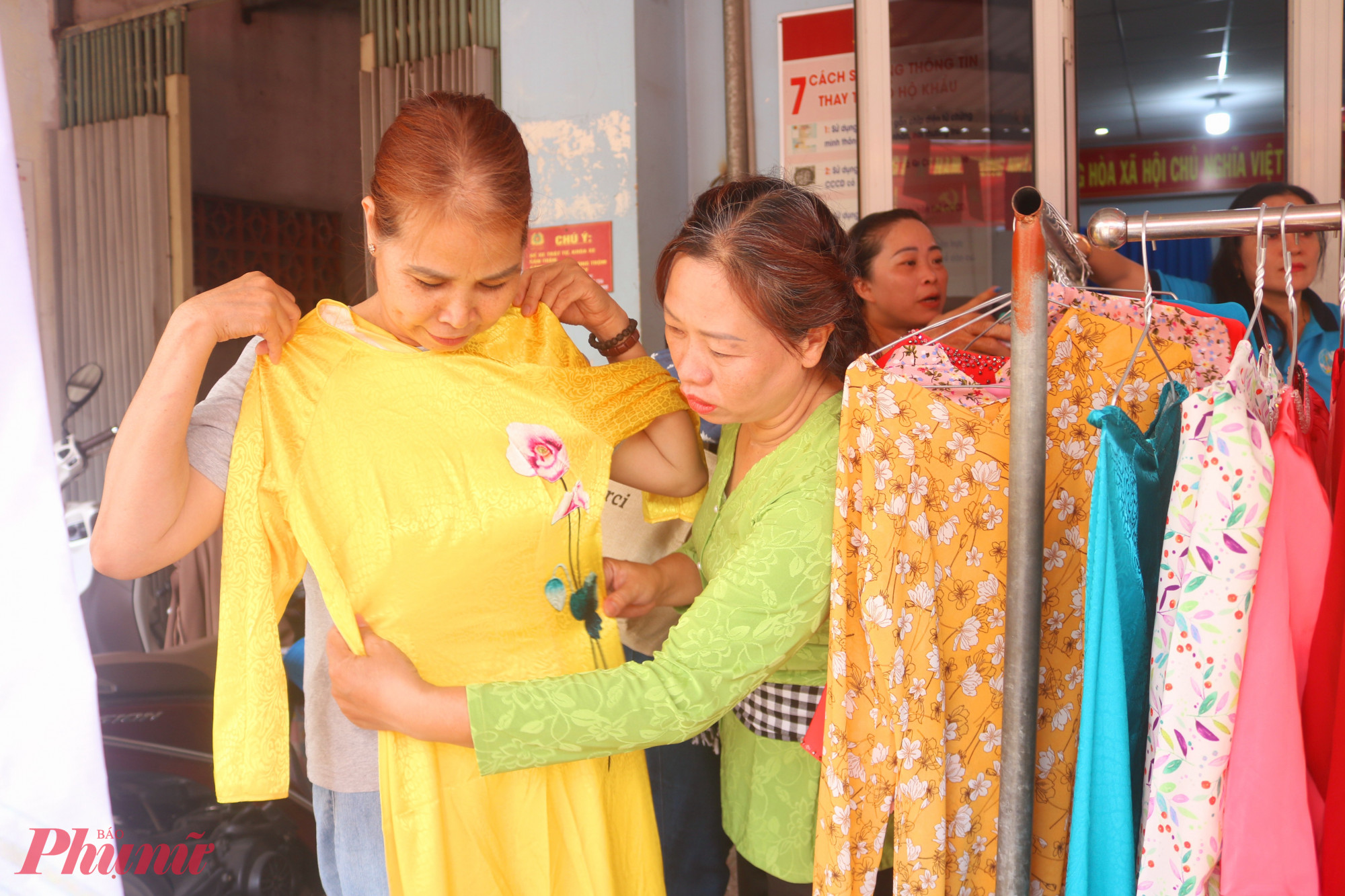 Các dì, các chị giúp nhau lựa chọn bộ áo dài vừa vặn, ưng ý nhất - Ảnh: Thảo Nguyên