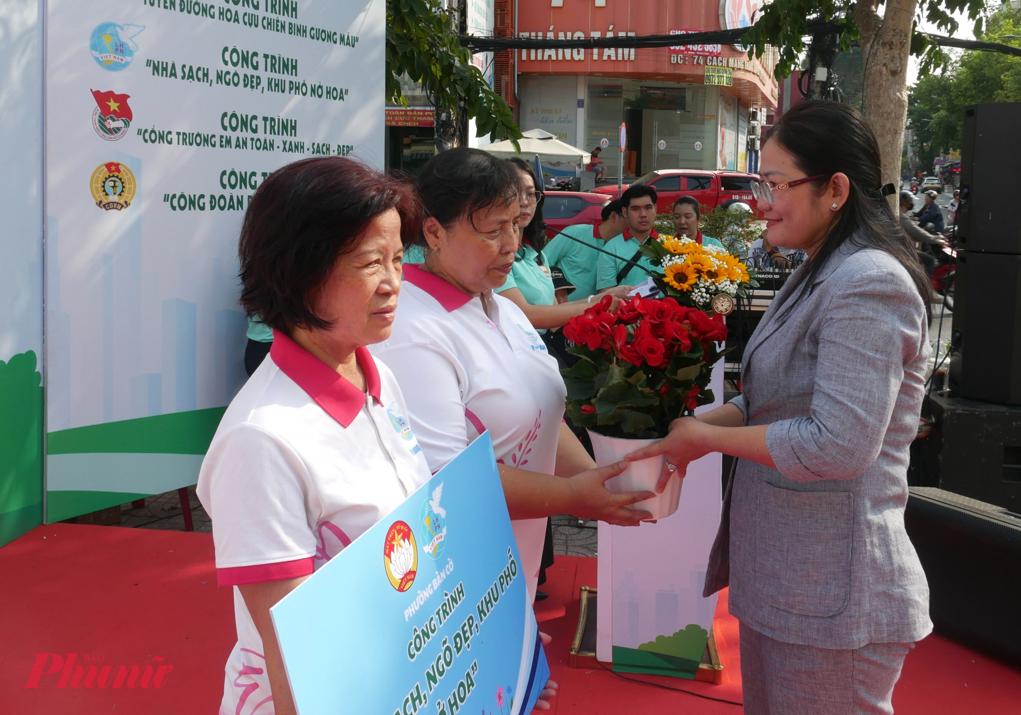 Bà Trần Thị Thu Hường - Phó bí thư thường trực Đảng ủy phường Bàn Cờ - trao hoa đền các chi hội phụ nữ khu phố đăng ký thực hiện công trìnhNhà sạch - Ngõ đẹp - khu phố nở hoa - Ảnh: Trang Nguyễn 
