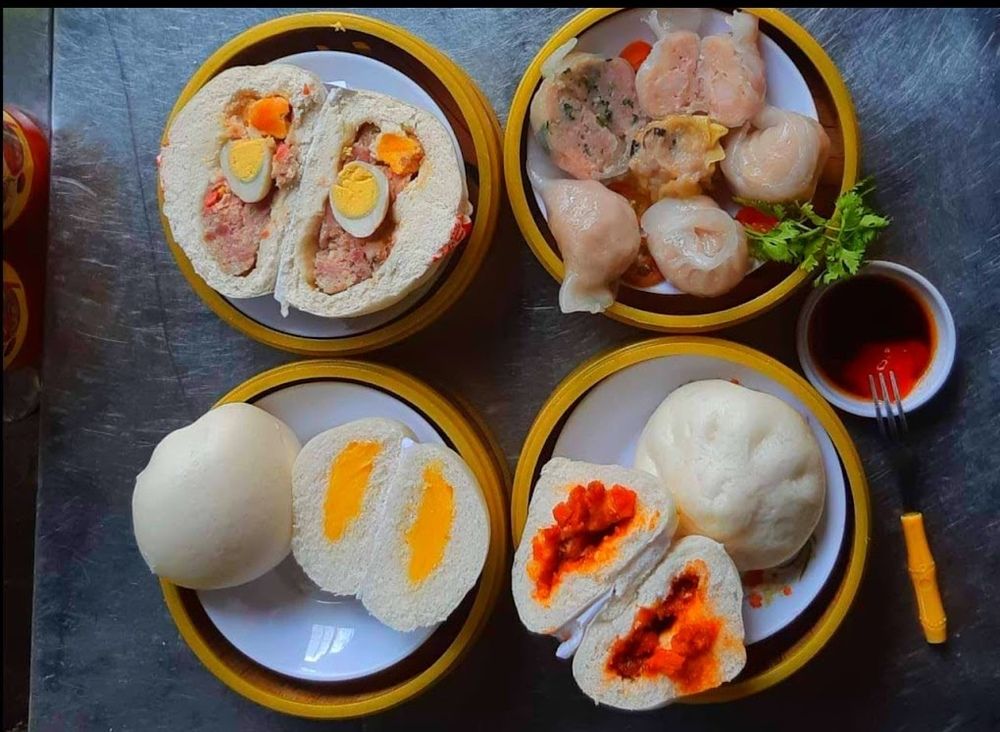Từng viên há cảo trắng trong, lớp vỏ mềm dai ôm lấy phần nhân đậm đà; xíu mại thì béo thơm, ăn kèm nước tương pha sa tế cay nhẹ càng bắt vị. Đây là món không quá no nhưng lại rất hợp để vừa trú mưa vừa nhẩn nha thưởng thức. Cảm giác mở nắp xửng, làn khói nóng phả lên mặt giữa tiết trời se lạnh khiến món ăn dân dã này bỗng trở nên cuốn hút lạ thường.
