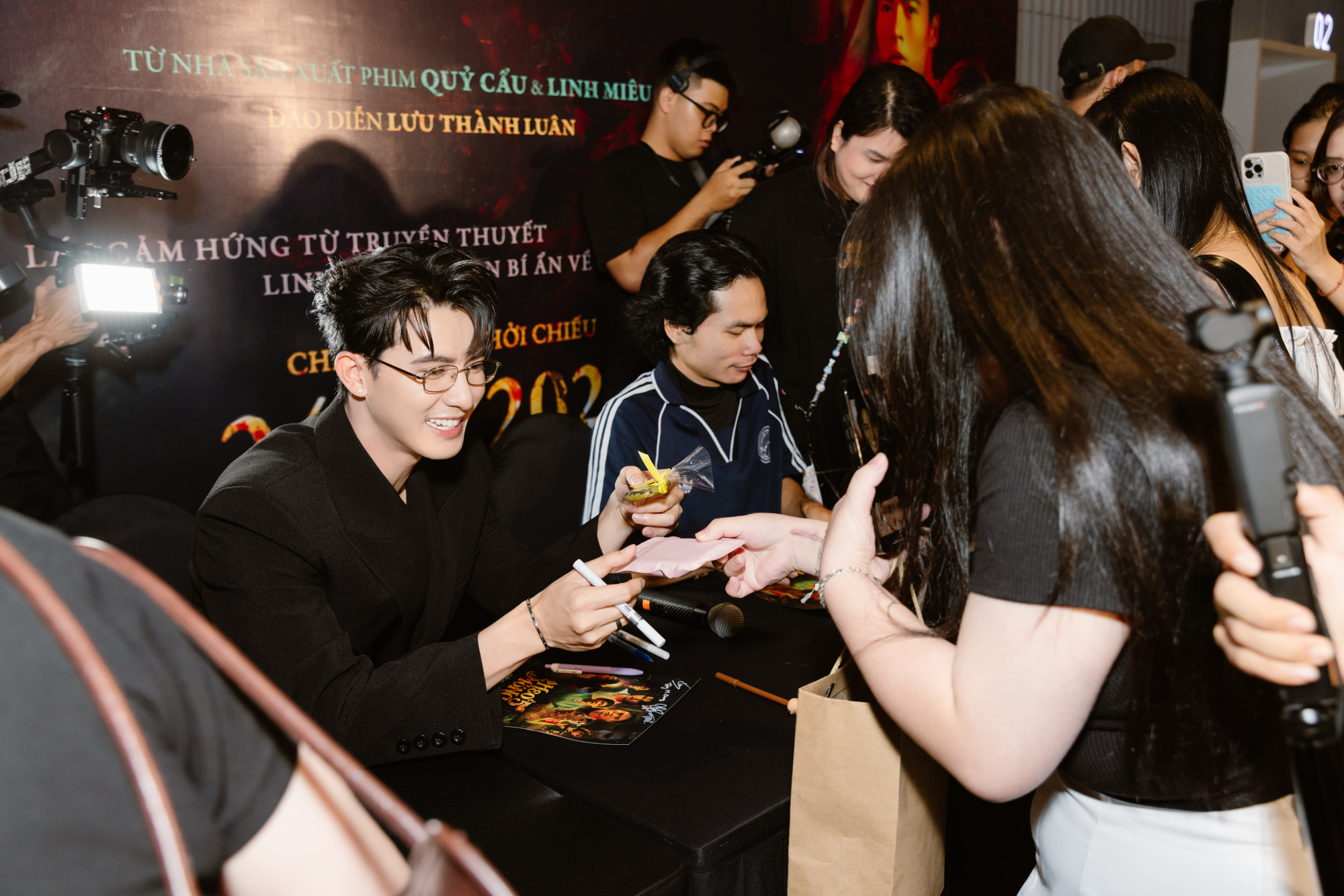 Diễn viên Trần Ngọc Vàng nhận quà từ fan trong buổi fansign phim Heo 5 móng. Ảnh: ĐPCC
