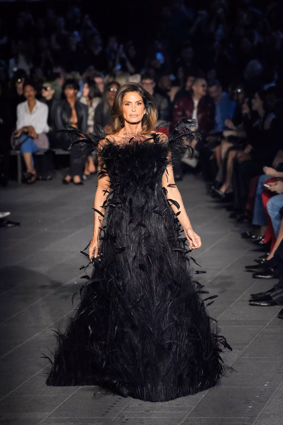Cindy Crawford diện váy lông vũ sắc đen huyền bí đảm nhận vị trí kết màn show của Gucci Cruise 2027 tại Quảng trường Thời đại ở Thành phố New York - Ảnh: Eduardo Munoz