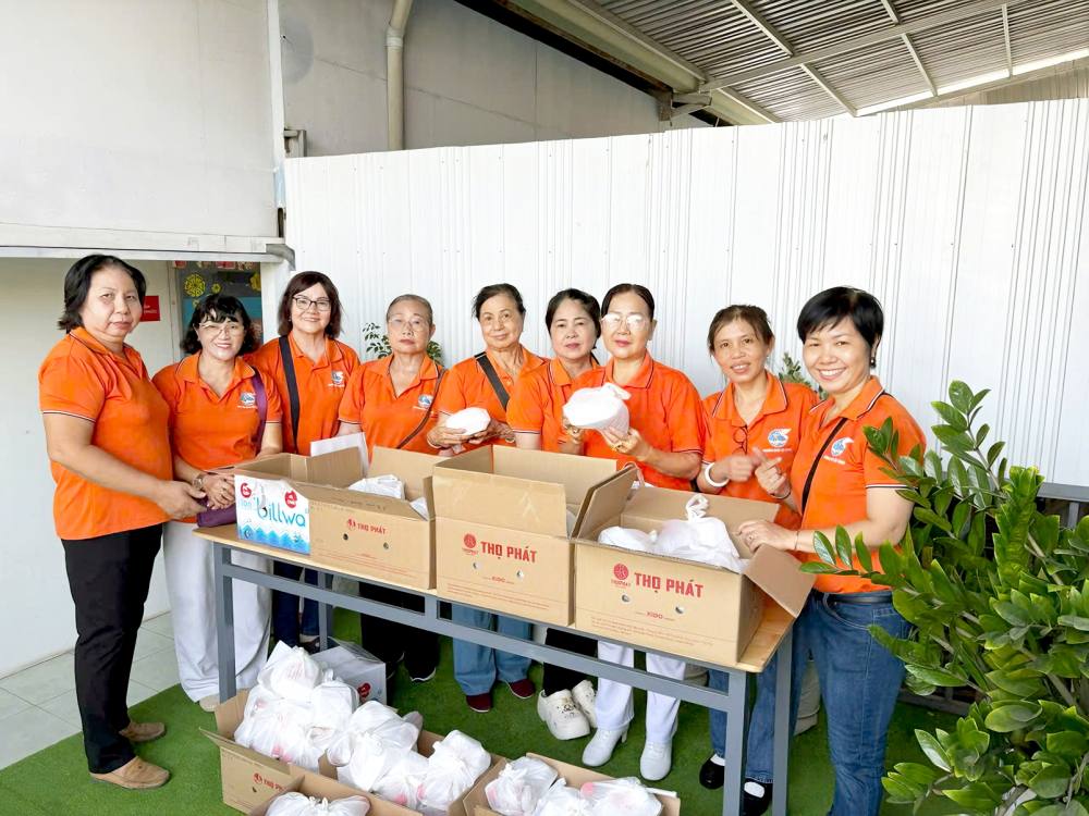Chị Lâm Thị Huỳnh Lan (bìa phải) - Chi hội trưởng Chi hội Phụ nữ khu phố 39,  phường Bình Lợi Trung - cùng chị em khu phố chuẩn bị các suất ăn yêu thương trao tặng bà con
