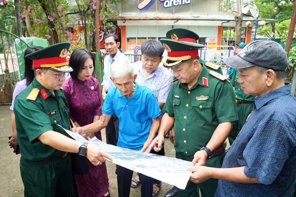 Các nhân chứng và chuyên gia cùng khảo sát thực địa để xác minh vị trí các hố chôn tập thể trong công viên Lê Thị Riêng - ẢNH: THANH TÂM