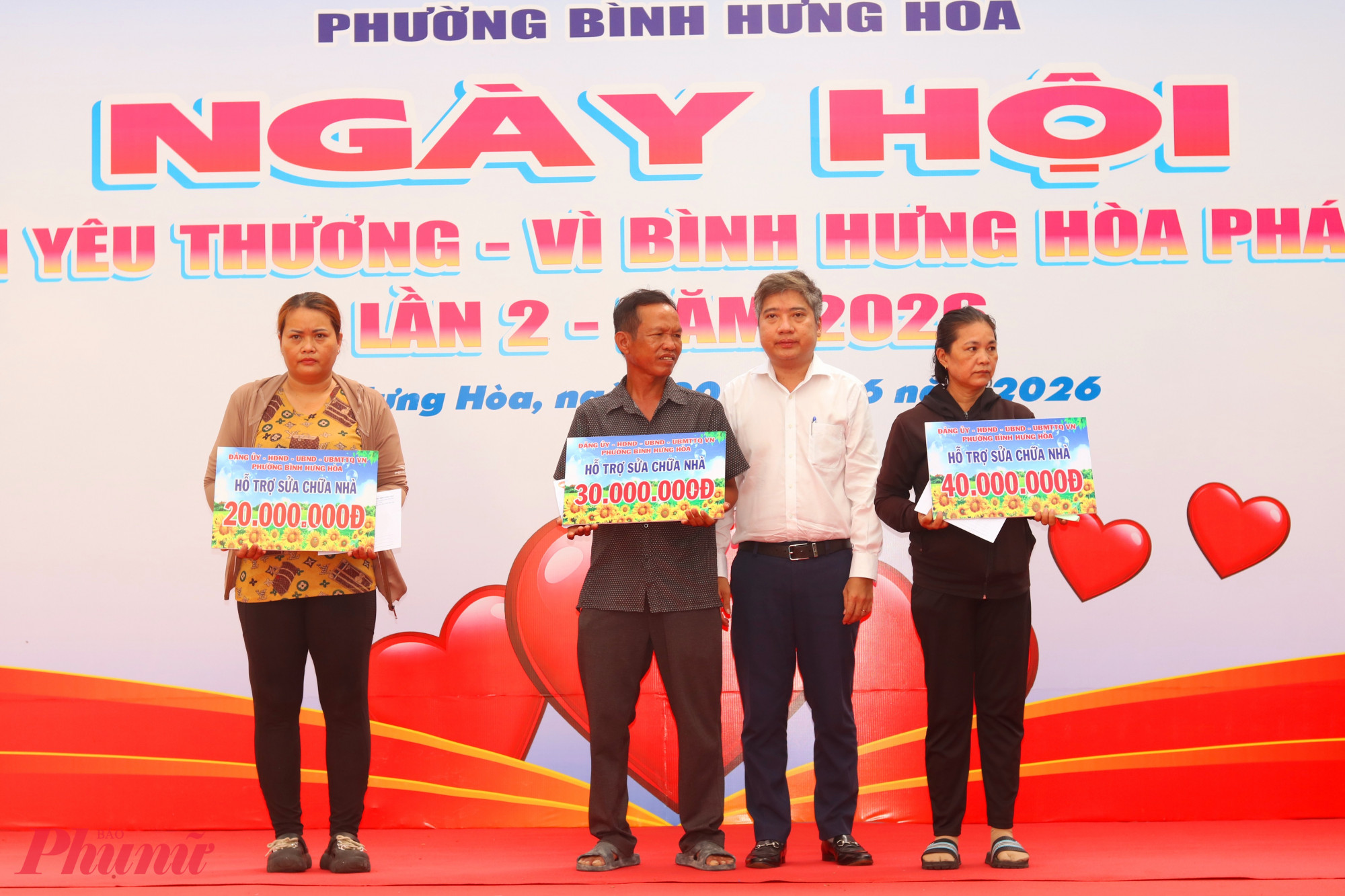 Ngày của yêu thương Ông Nguyễn Việt Quế Sơn – Bí thư Đảng ủy, Chủ tịch HĐND phường Bình Hưng Hòa (thứ 2, từ phải qua) – trao bảng tượng trưng kinh phí hỗ trợ 3 hộ gia đình sửa chữa nhà - Ảnh: Mẫn Nhi