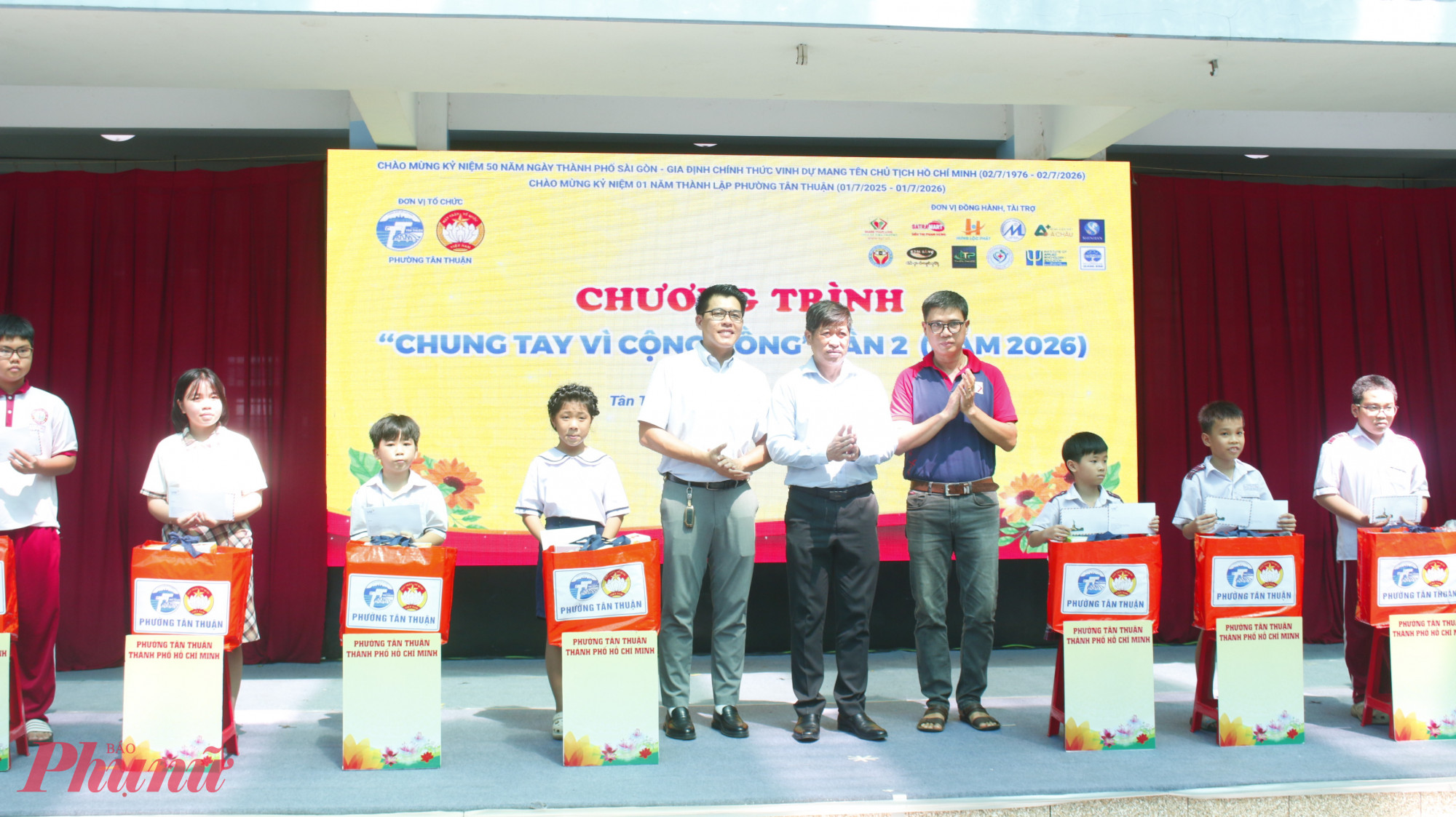 Lãnh đaọ phường Tân Thuận và các đơn vị tài trợ trao quà đến các em học sinh hiếu học vượt khó, mỗi phần quà trị giá 2,4 triệu đồng